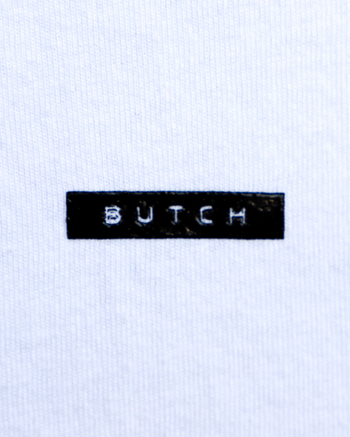 Closeup of butch label shirt black on white