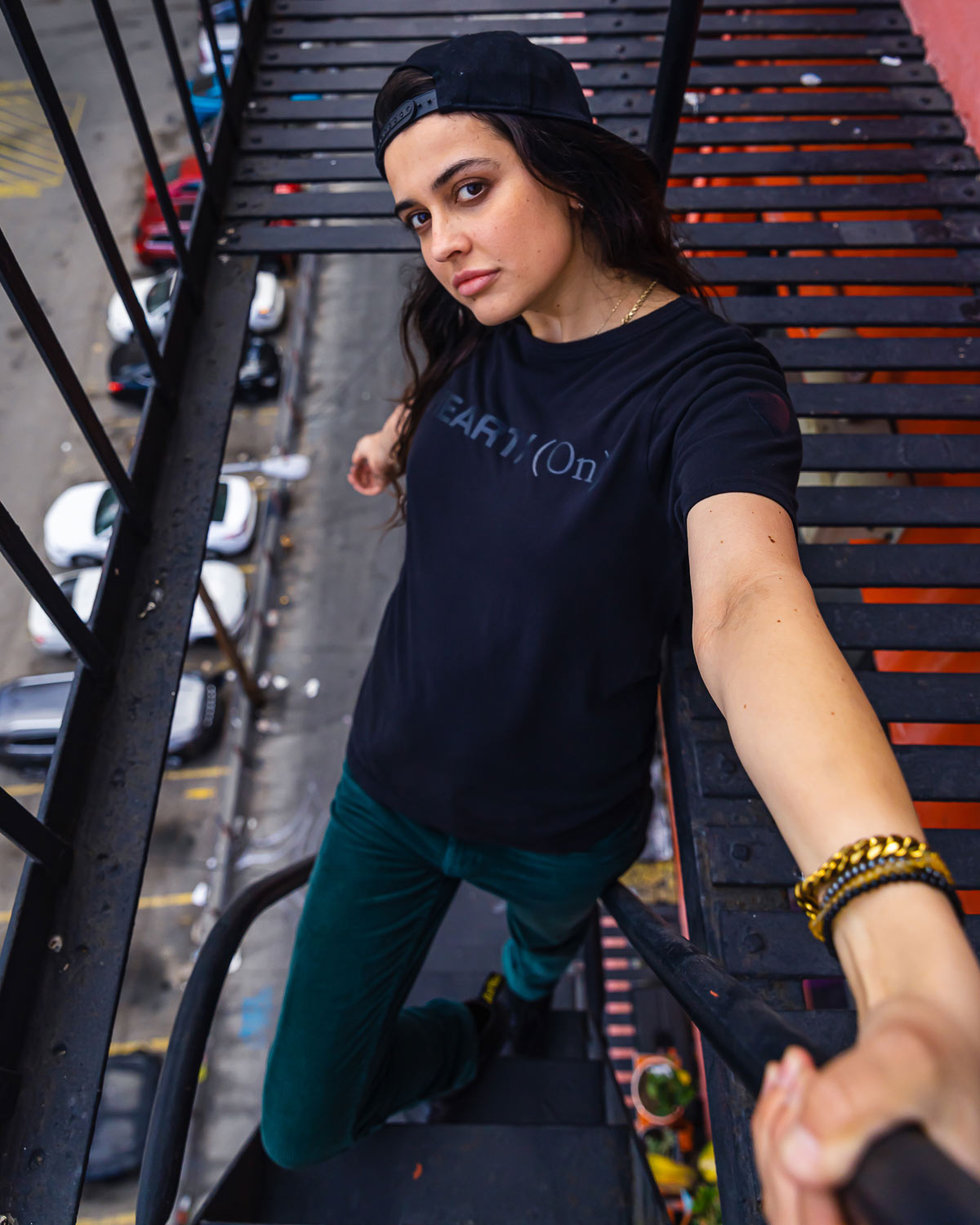Model wearing Black Heart On logo t-shirt on fire escape