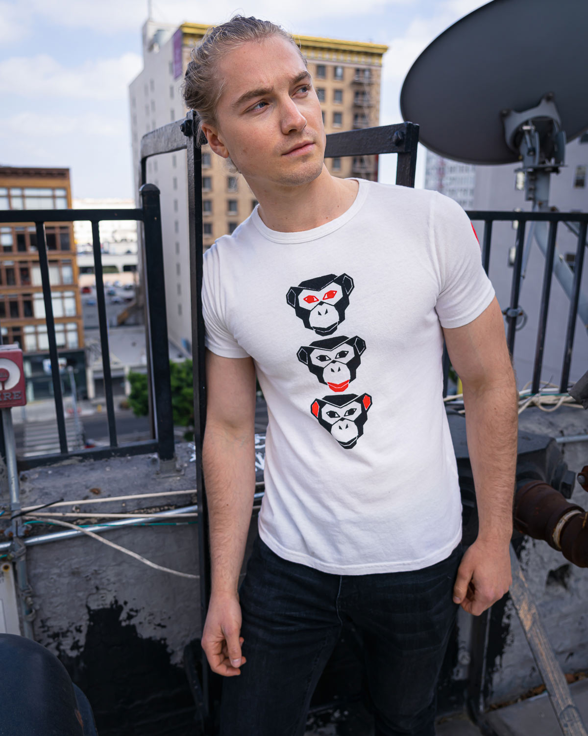 Model wearing Vintage white see evil t-shirt on rooftop
